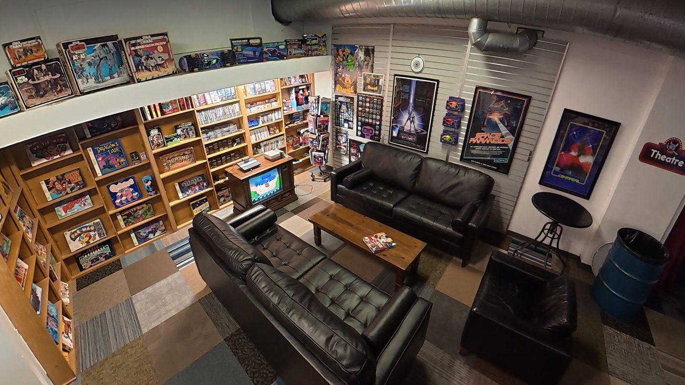Retro lounge with leather couches and shelves of console games